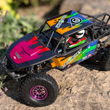 Custom Painted off-road RC Crawler on a rocky surface with blurred greenery in the background