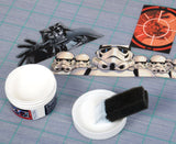 Dark Vader and Storm Troopers trimmed from magazine, ready to be glued into a Star Wars themed RC car body using xxx main Picture Glue. 