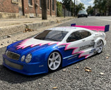 Protoform RC Touring Car body painted with Saw Blade pre-cut vinyl Paint Masking Stencils blue, pink, and white. 